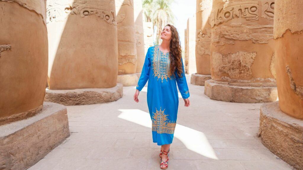 traveling egypt: woman enjoying a tour at the great temple of amun in karnak, egypt